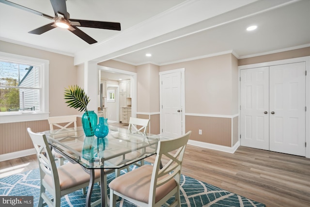 dining room with ceiling fan, light hardwood / wood-style flooring, and crown molding