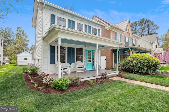 view of front of house with a front yard and covered porch