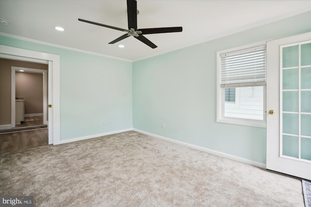 carpeted empty room with ornamental molding and ceiling fan