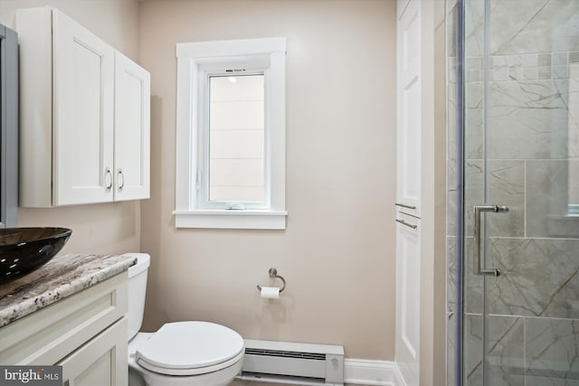 bathroom with a shower with door, a baseboard radiator, toilet, and large vanity