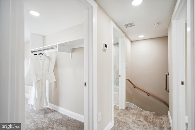 hallway with light colored carpet