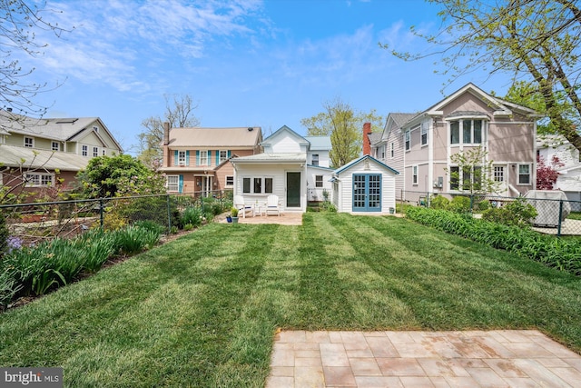 rear view of property with a patio area and a lawn