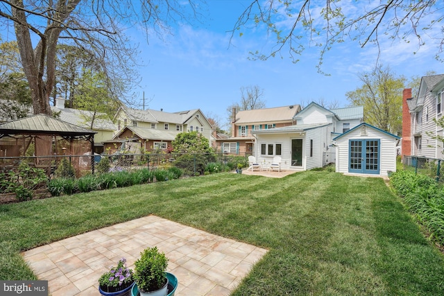 rear view of house featuring a patio and a lawn