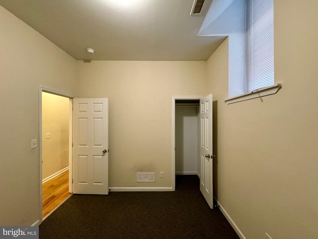 unfurnished bedroom featuring dark colored carpet