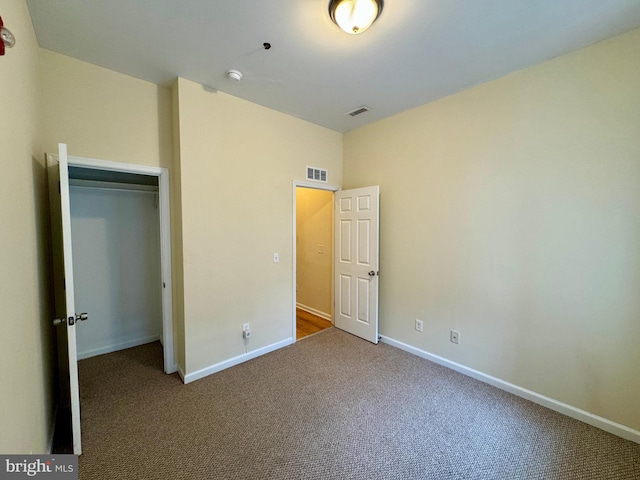 unfurnished bedroom with carpet and a closet