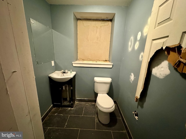 bathroom featuring tile patterned floors, vanity, and toilet