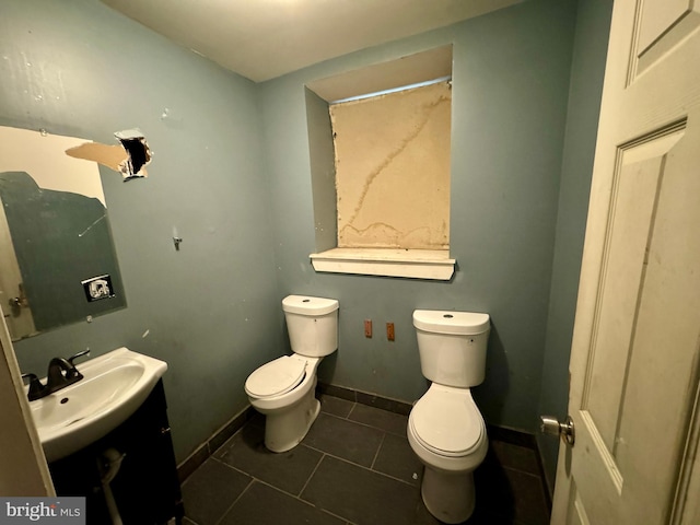 bathroom featuring tile patterned floors, vanity, and toilet