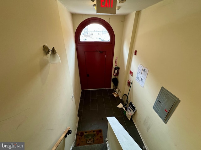 entryway featuring dark tile patterned floors