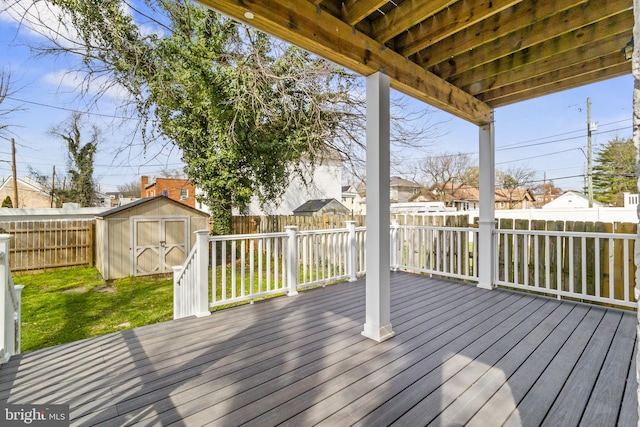 wooden terrace with a yard and a shed