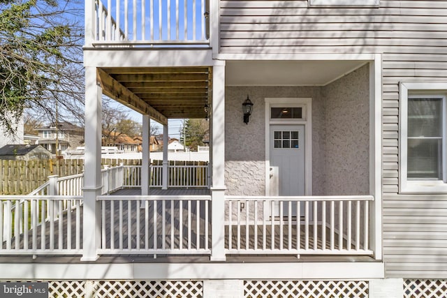 view of exterior entry featuring a balcony