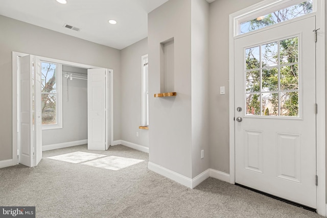 doorway to outside featuring light carpet