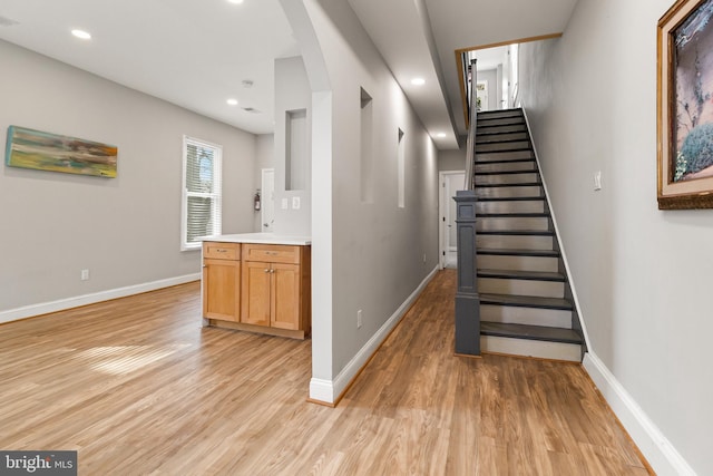 staircase with light hardwood / wood-style floors