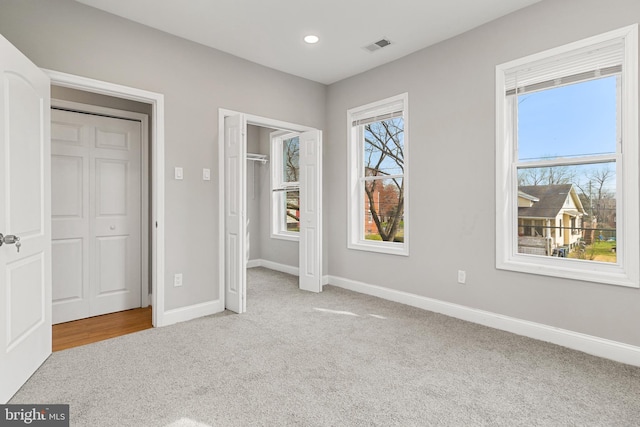 unfurnished bedroom featuring light carpet