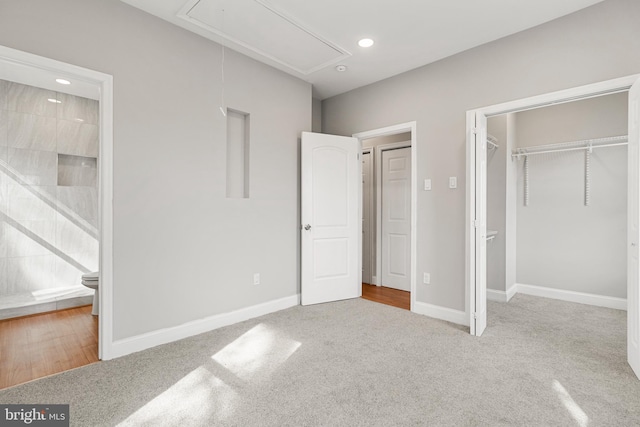 unfurnished bedroom featuring light colored carpet and a closet