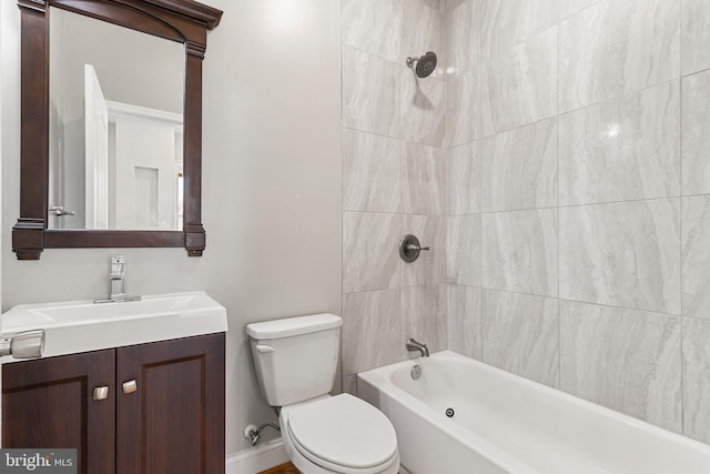 full bathroom with tiled shower / bath combo, toilet, and vanity