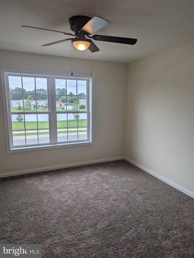 spare room with ceiling fan and carpet flooring