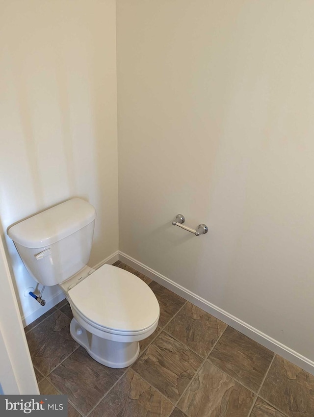 bathroom with tile patterned flooring and toilet