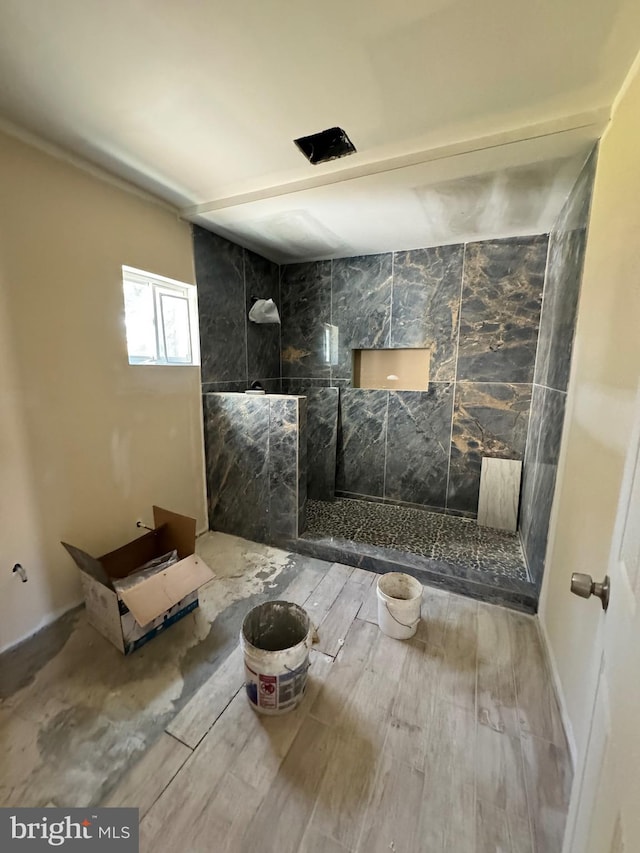 interior space featuring tiled shower