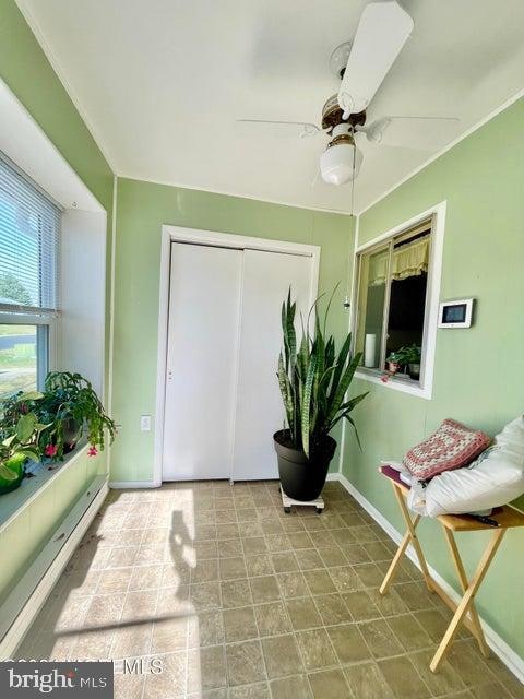 sunroom / solarium with ceiling fan