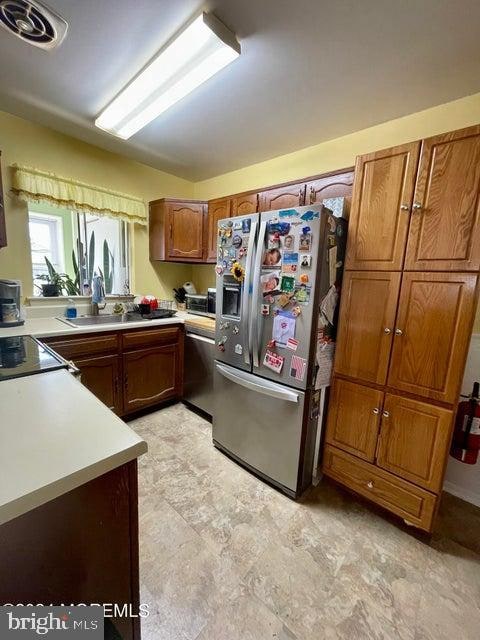 kitchen featuring appliances with stainless steel finishes and light tile floors