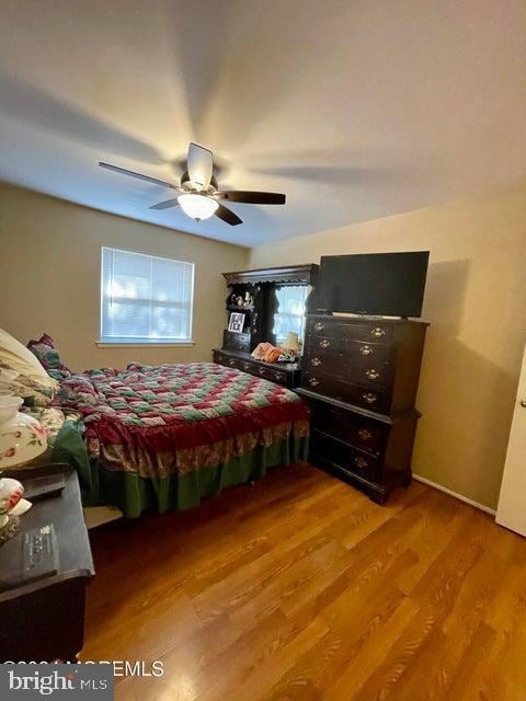 bedroom featuring hardwood / wood-style floors and ceiling fan