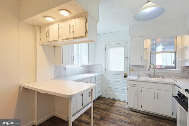 kitchen featuring range with electric stovetop, white cabinetry, tasteful backsplash, and dark wood-type flooring