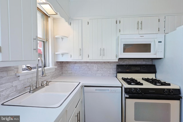 kitchen featuring white appliances, white cabinets, a healthy amount of sunlight, and sink