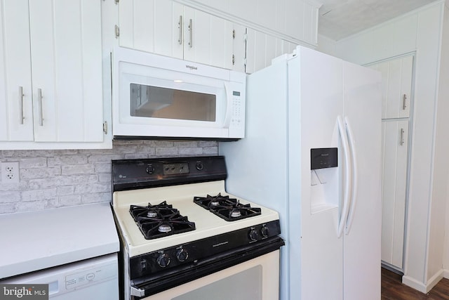 kitchen featuring white appliances, white cabinets, backsplash, and dark hardwood / wood-style flooring