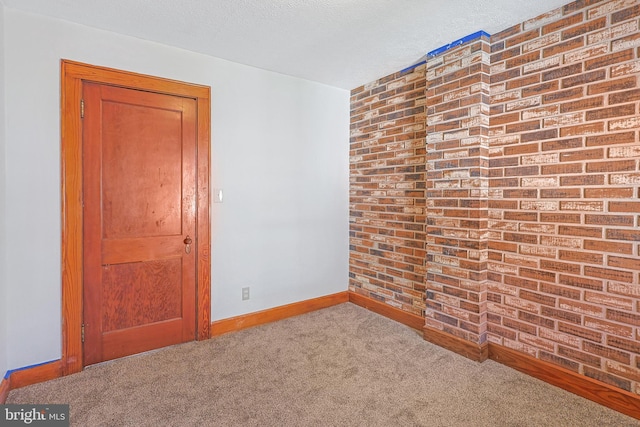 unfurnished room featuring a textured ceiling and carpet