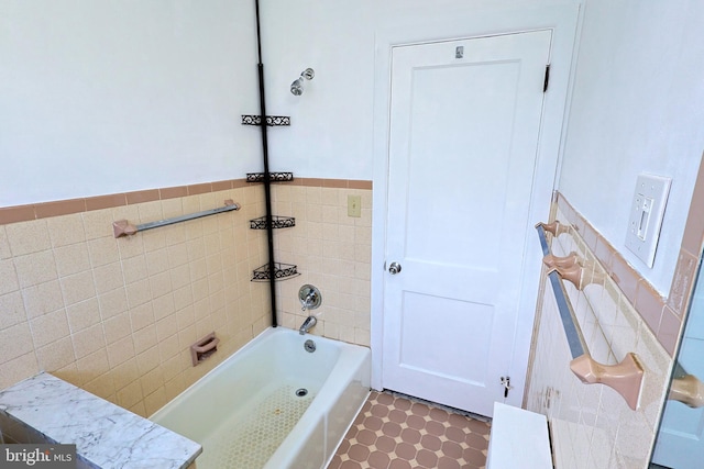 bathroom featuring tile flooring and tile walls