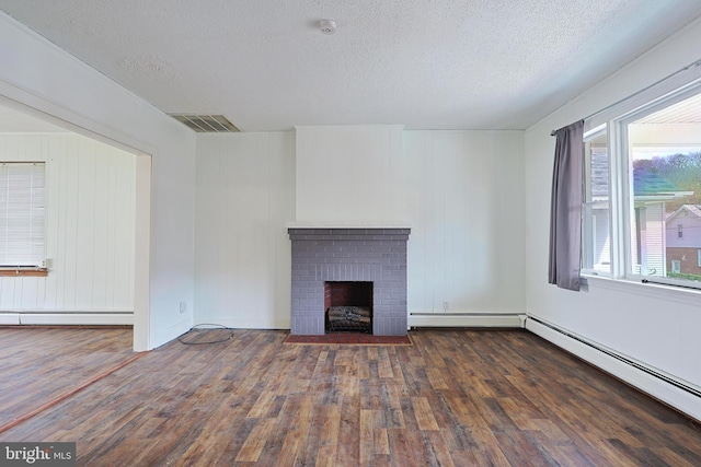 unfurnished living room with a fireplace, a textured ceiling, and dark wood-type flooring