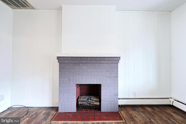 details featuring a brick fireplace and dark hardwood / wood-style floors