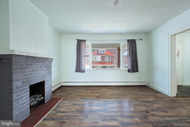 unfurnished living room featuring a brick fireplace, dark hardwood / wood-style floors, a baseboard heating unit, and a textured ceiling