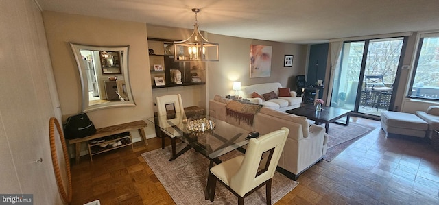 living room with a chandelier and dark parquet floors