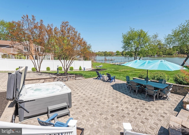 view of patio featuring a water view and a hot tub