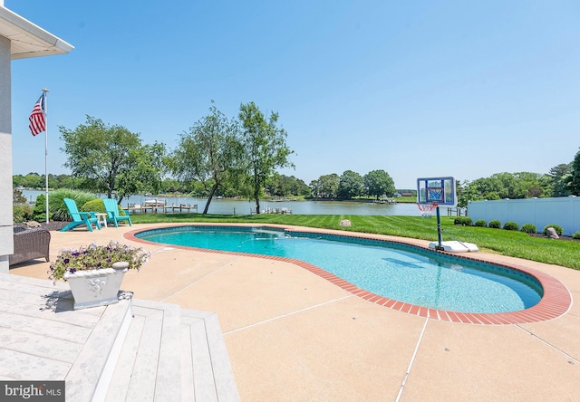 view of swimming pool with a water view, a yard, and a patio