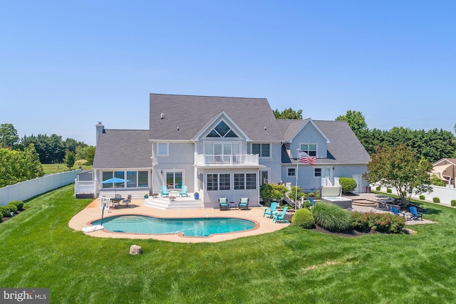 back of house featuring a yard, a patio area, a balcony, and an outdoor hangout area