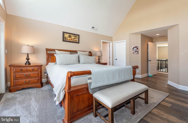 bedroom featuring high vaulted ceiling and dark hardwood / wood-style floors