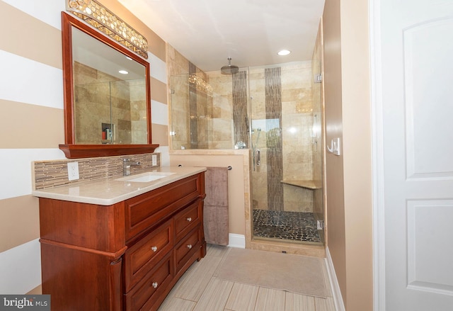 bathroom with backsplash, vanity, and walk in shower