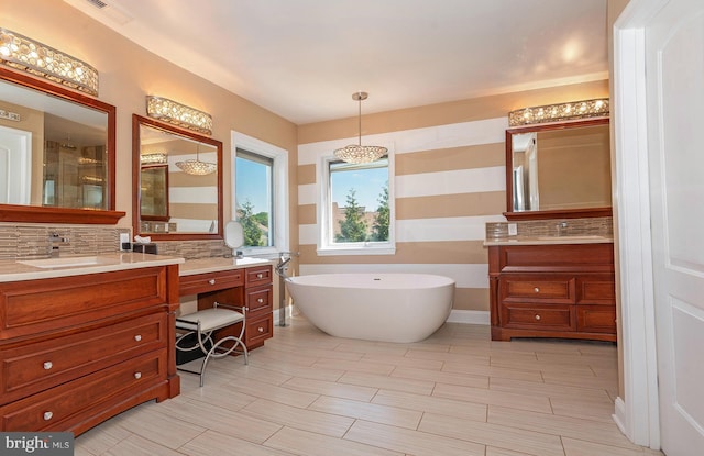 bathroom featuring decorative backsplash, separate shower and tub, and vanity