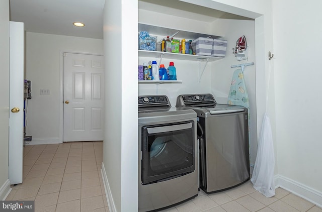 laundry room with light tile patterned floors and washing machine and dryer