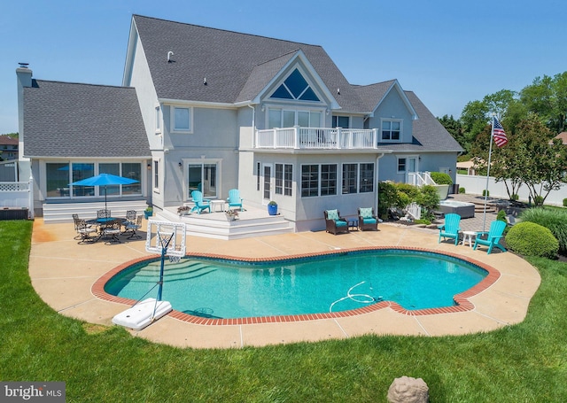 rear view of property with a patio area and a balcony