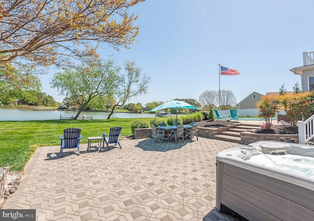 view of patio featuring a water view and a hot tub