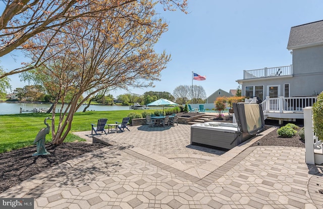 view of patio / terrace with a balcony and a deck with water view