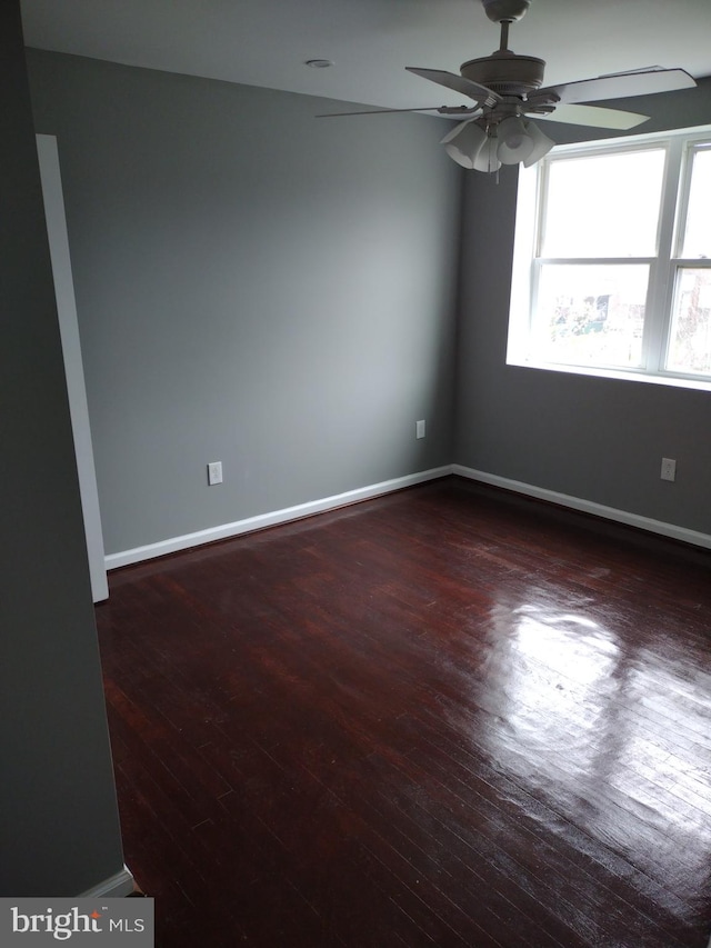 unfurnished room featuring ceiling fan and dark hardwood / wood-style floors