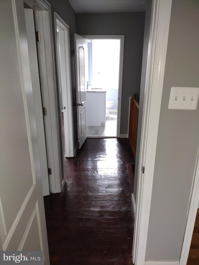 hallway with dark hardwood / wood-style flooring