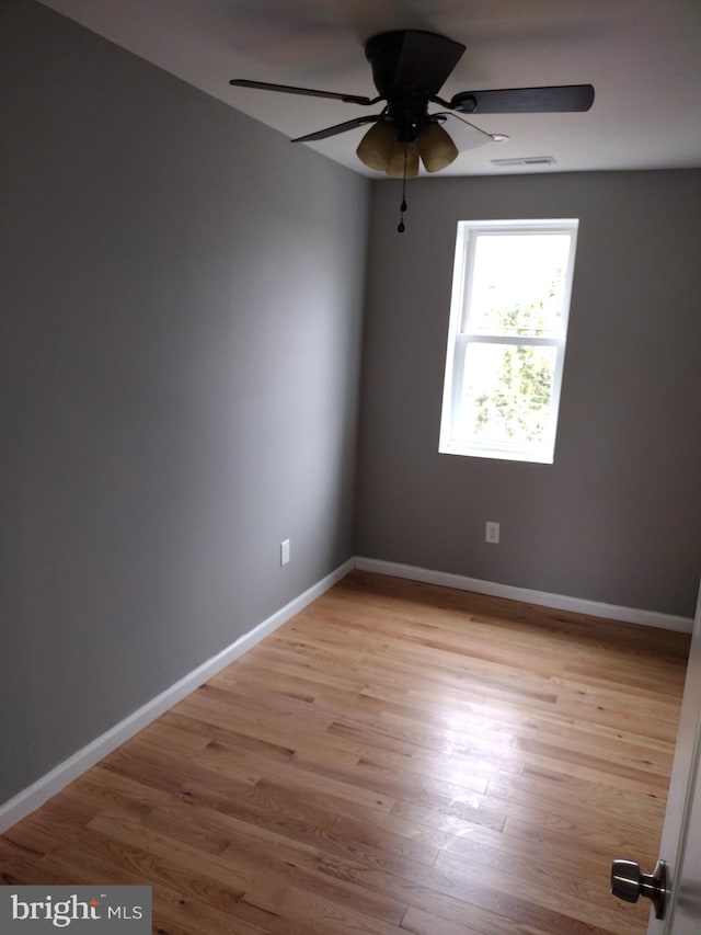 spare room featuring ceiling fan and light hardwood / wood-style floors