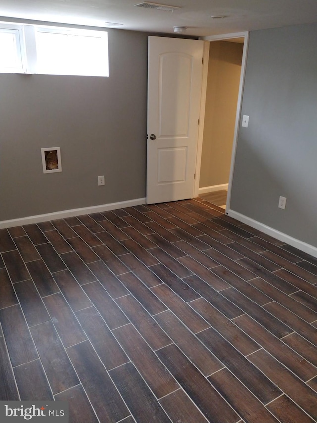 basement with dark hardwood / wood-style flooring