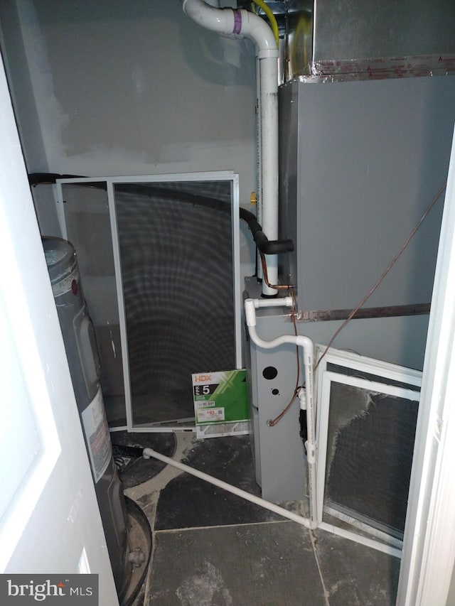 utility room featuring water heater