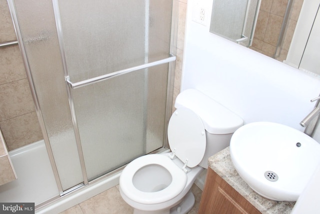 bathroom featuring walk in shower, toilet, tile flooring, and vanity